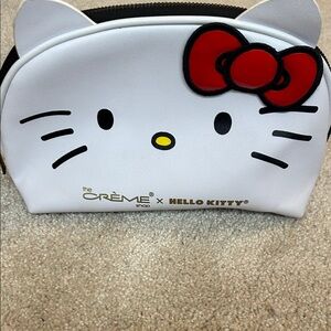 The Crème x Hello Kitty White Kids Cosmetic Pouch with Red Bow Accent